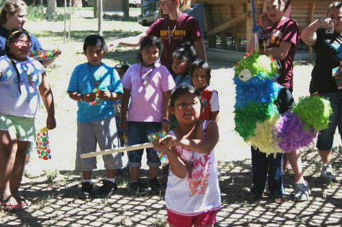 Children Swinging at Piñata