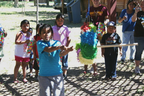 Children Swinging at Piñata