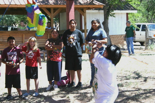 Children Swinging at Piñata