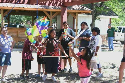 Children Swinging at Piñata