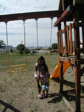 Girl Pushing Another Girl on Swing