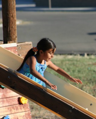 Girl Going Down Slide