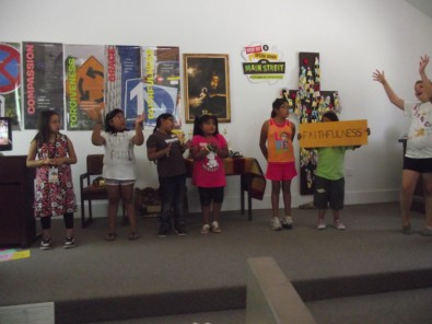 Child Holding Sign Saying "Faithfulness"