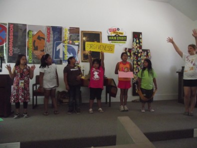 Child Holding Sign Saying "Forgiveness"
