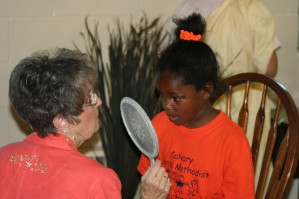 Checking Her Painted Eyes in Mirror 