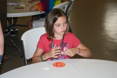 Child Drawing Smiley Face for Straw