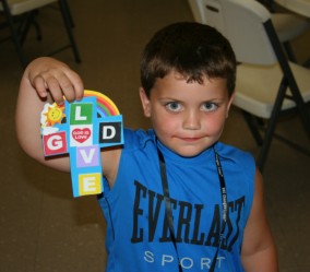 Boy Showing Cross