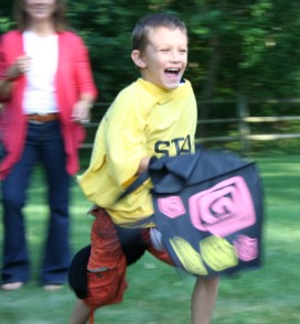 Boy Running with Bag and Clothing Articles