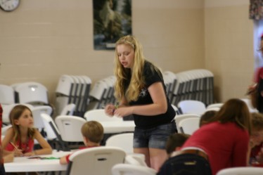 Youth Helping Children with Crafts