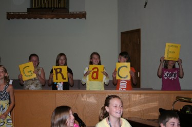 Children Holding up Cards with the Letters G-R-A-C-E