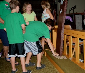 Children Placing Rocks at the Foot of the Cross