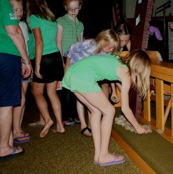 Children Placing Rocks at the Foot of the Cross