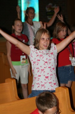 Girl Singing with Arms Raised