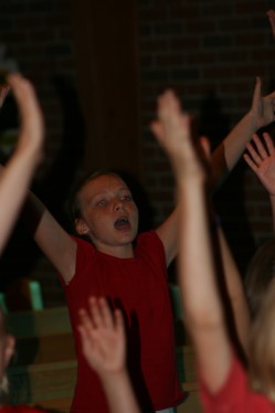 Girl Singing with Arms Raised