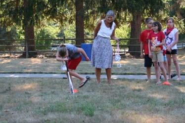 Child Spinning Around Bat