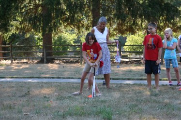 Child Spinning Around Bat