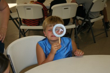 Child Looking Through Toy Magnifying Glass