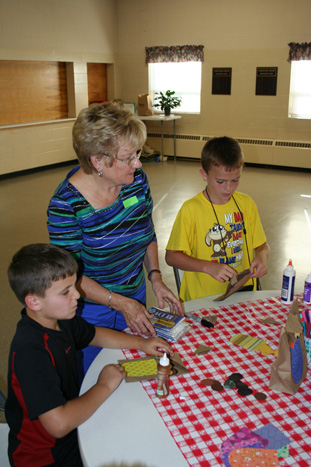 Lana Helping Children Make "Popcorn Pal" Bag