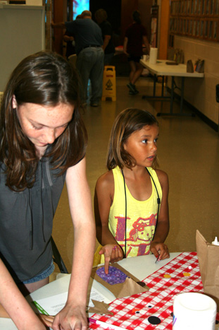 Taylor Helping Child Make "Popcorn Pal" Bag