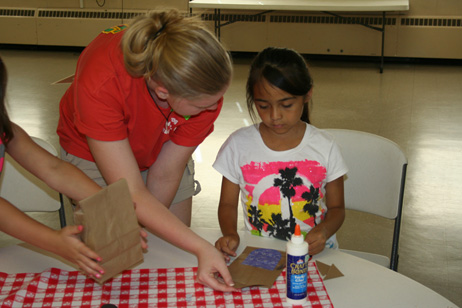 Liz Helping Child Make "Popcorn Pal" Bag