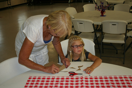 Sue Helping Child Make "Popcorn Pal" Bag