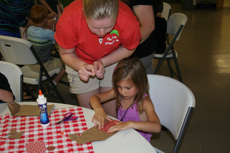 Liz Helping Child Make "Popcorn Pal" Bag