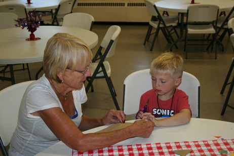 Sue Helping Child Make "Popcorn Pal" Bag