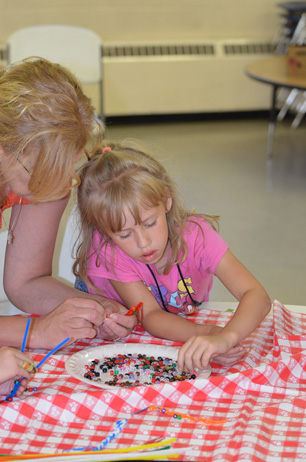 Sharon Assisting Girl with Bookmark