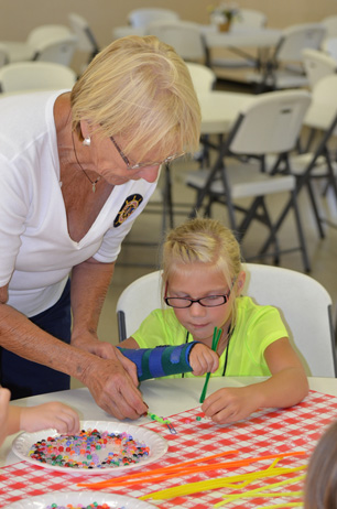 Sue Assisting Girl with Bookmark