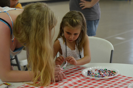 Liz Helping Child with Bookmark