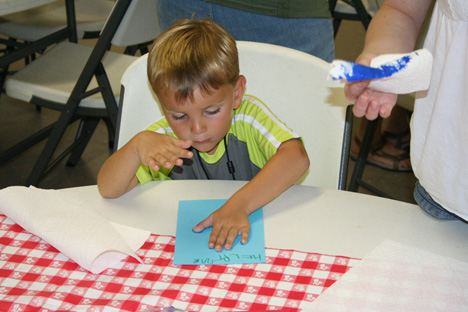 Boy Pressing Hand on Paper