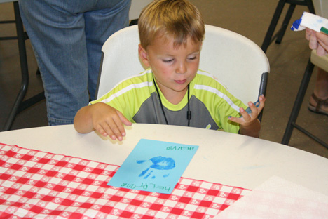 Boy Looking at Blue Paint on Hand