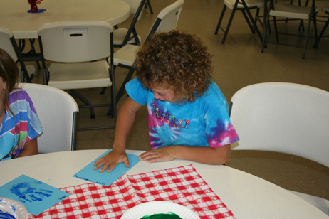 Girl Pressing Hand on Paper