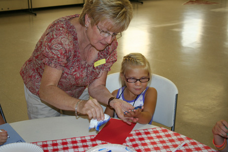 Lana Putting Paint on Girl's Hand