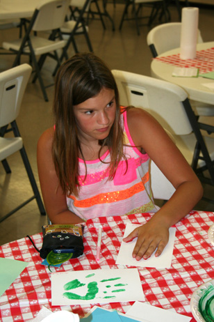 Girl Pressing Hand on Paper