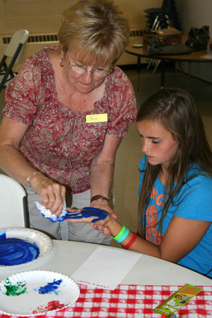 Lana Putting Paint on Girl's Hand