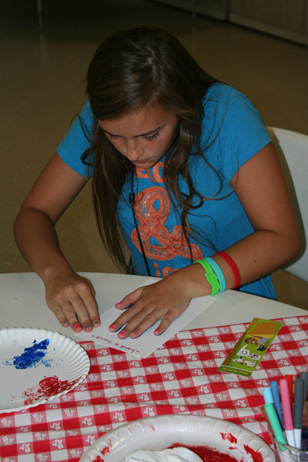 Girl Pressing Hand on Paper