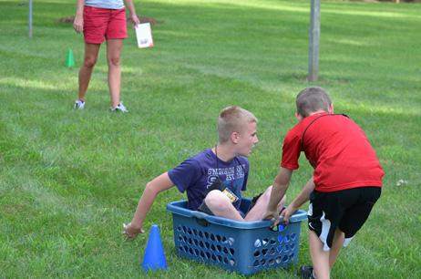 Boy Pulling Another Boy in Laundry Basket