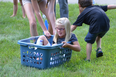 Boy Pulling Girl in Laundry Basket