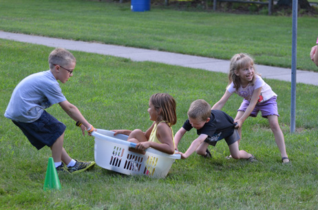 Boy Pulling and Boy & Girl Pushing Girl in Laundry Basket