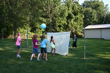 Kids Tossing Ball Over Sheet