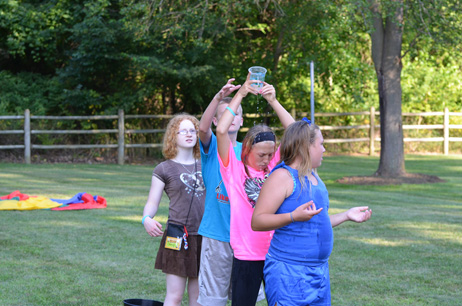 Kids Passing the Dripping Cup over Their Head