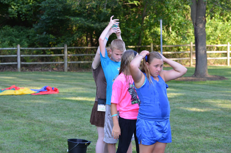 Kids Passing the Dripping Cup over Their Head