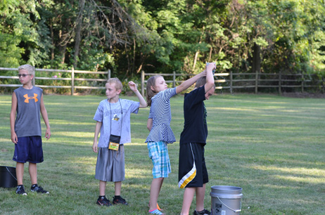 Kids Passing the Dripping Cup over Their Head