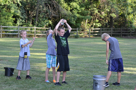 Kids Passing the Dripping Cup over Their Head