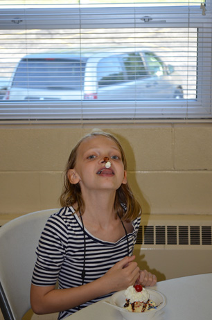 Girl Eating Ice Cream & with Whippeed Cream & Cherry on Nose