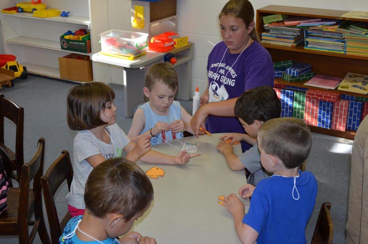 Youth Helping Children with Fish Crafts