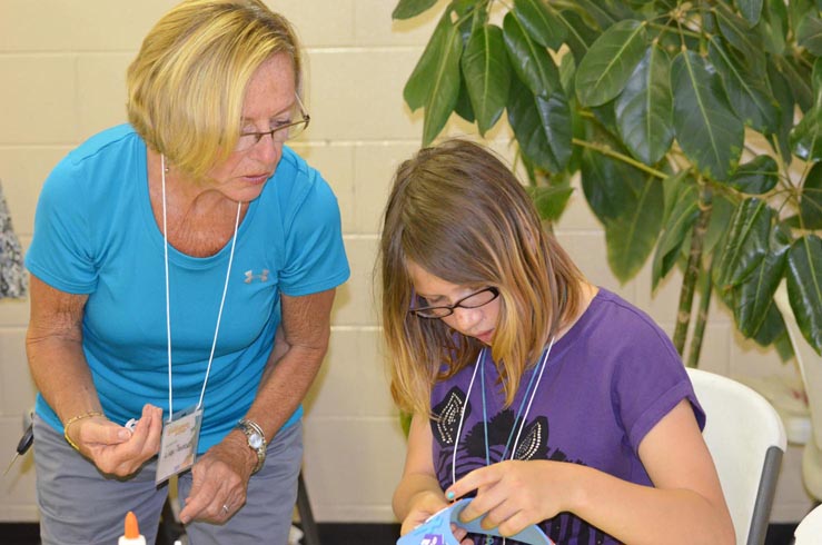 Linda Helping Girl with Sun Visor