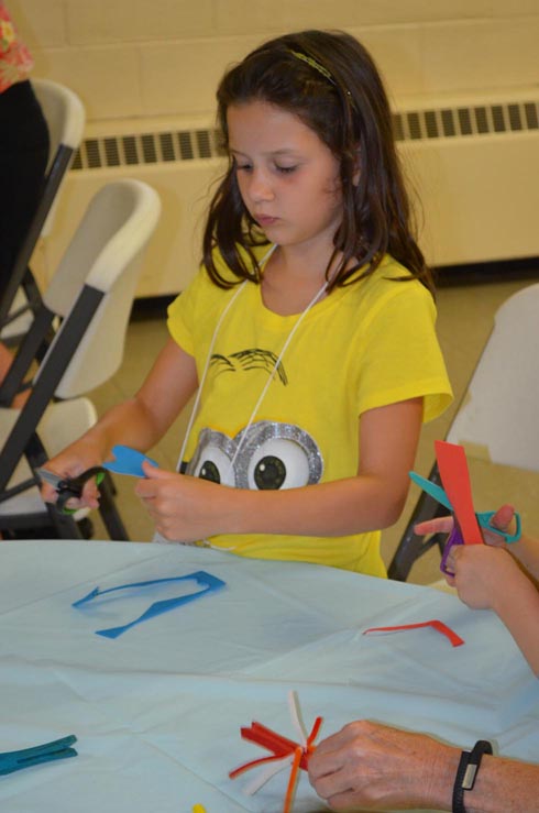 Girl Cutting out Dragon Fly Wings