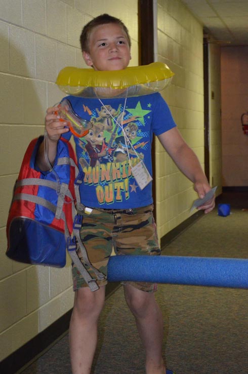 Boy Dressed with Float Ring, Goggles & Life Vest